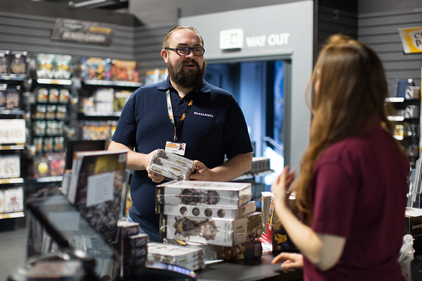 Games Workshop retail employee holding products