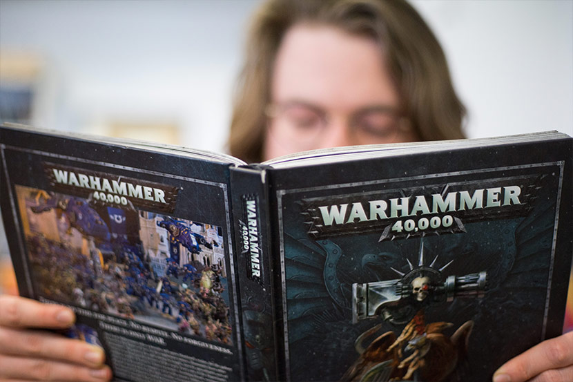Person reading Warhammer 40K book